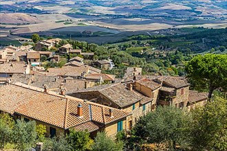 Above the rooftops of Montalcino, view of the Val dOrcia valley
