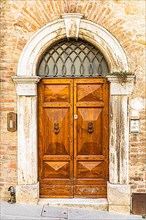 Ornate round arched front door, San Quirico