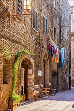 Medieval building with coloured laundry on the clothesline, San Gimignano