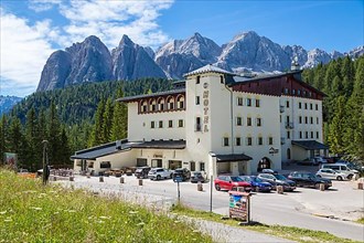 Large hotel in front of Alpine panorama, Dolomites