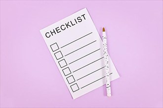 White empty checklist with pencil on violet background,