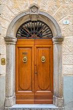 Ornate round arch front door, Montalcino