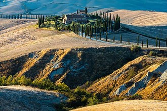 The country house Baccoleno on hills of the Crete Senesi in the evening light, near Asciano