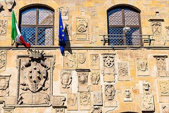 The Italian and European flags fly on the facade of Palazzo Pretorio, Arezzo
