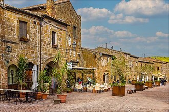 Old stone houses with street cafes in Sovana, Sovana