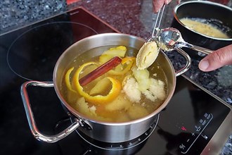 Swabian cuisine, preparation of sweet semolina dumplings in hot water with oranges and lemon zest