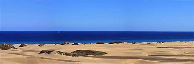 The dunes of Playa Del Ingles with a view of the Atlantic Ocean. San Bartolome de Tirajana, Gran Canaria
