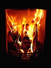 Cosy stove fire with burning logs,