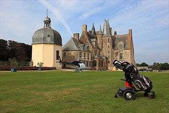 Golf trolley in front of the Chateau des Rochers-Sevigne with chapel, near Vitre