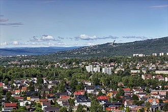 View from Grefsenkollen of houses and wooded areas, view of the city and Mount Holmenkollen with ski jump