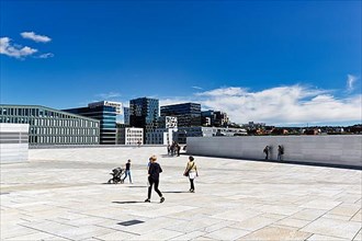 Pedestrians on the white roof of the opera house, modern architecture