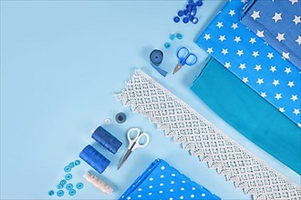 Sewing flat lay with various tools like fabric, scissors