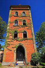 Historic red castle tower under a steel blue sky. Schillingsfuerst, Ansbach