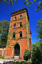 Historic red castle tower under a steel blue sky. Schillingsfuerst, Ansbach
