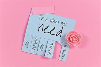 Blue tear-off stub note with text Take what you need and words Love, Freedom