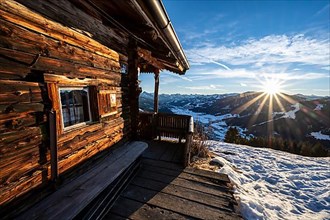 Terrace of a mountain hut, view into the Brixen valley in winter sunshine