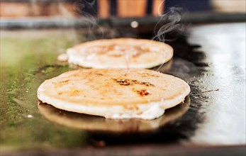 Traditional grilled cheese pupusas. Close up of traditional handmade pupusas on grill, Traditional Nicaraguan Pupusas on Grill