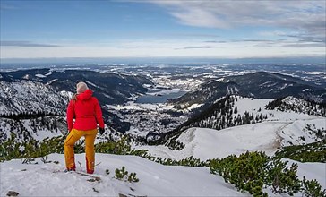 View of Schliersee, ski tourer at the summit of Jaegerkamp in winter