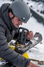 Ski tourers, man assembles his splitboard