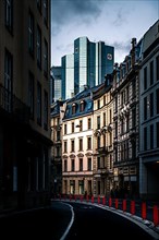 Street with old houses in Frankfurt in the background a modern glass building of the Deutschebank and the skyline, Frankfurt