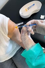 Elderly woman receives injection with medical syringe fourth vaccination booster vaccination against coronavirus disease Covid-19 C19 corona virus Corona virus, Germany