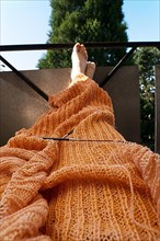 Knitted blanket with knitting needles,