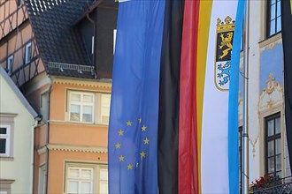 The Bavarian flag hanging outside a town hall of alongside the EU and German flags. Coburg, Germany