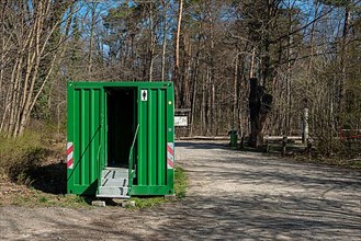 Green toilet container in Tegeler Forst, Berlin