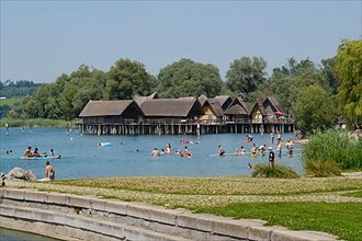 Bathers in Lake Constance in front of the pile dwellings at Unteruhldingen, open-air museum