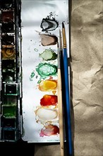 Watercolour paint box with brushes,