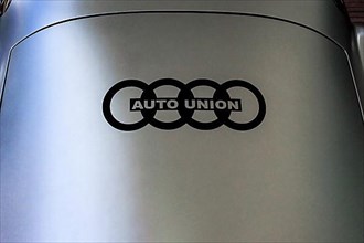 Historic logo of Auto Union with four rings of Audi on body of historic racing car sports car hiker Streamline Special, Classic Days