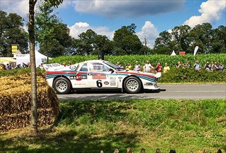 Classic historic racing car Lancia Rally 037 Martini Racing for rally group B at show race for classic cars, driver Walter Roehrl