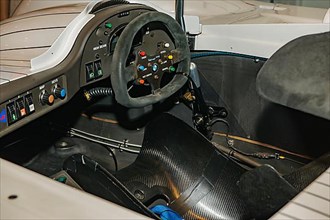 View into cockpit of historic racing car BMW V12 LMR Le Mans for 24h 24 hours race in 90s 1999 with dashboard modern steering wheel racing steering wheel, Messe Techno Classica