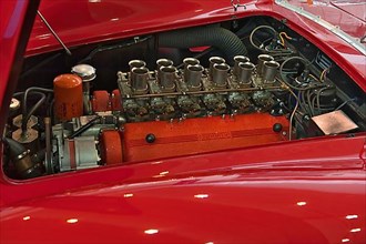 View under bonnet of classic car sports car Ferrari 250 TRC with 12 cylinder twelve cylinder engine, Techno Classica fair