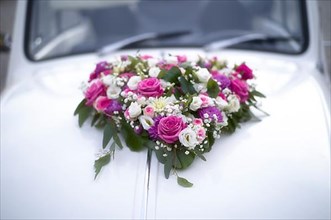 Flower heart, flower decoration on decorated wedding car