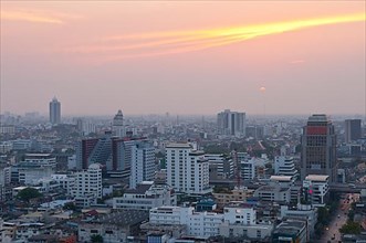 Sunset over downtown Bangkok with haze for agricultural burning, from rooftop restaurant of the Siam@Siam Hotel