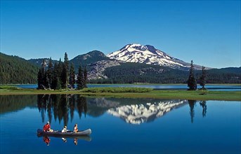 Father and children in canoe, Sparks Lake and South Sister