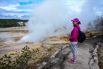 Young woman in Norris Geyser Basin, Yellowstone National Park