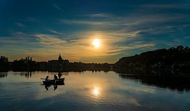 Rowing boat at sunset on the Ziegelsee, Moelln