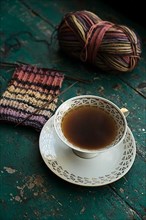 Handmade, Knitted piece with knitting needles and coffee
