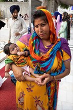 Indian woman in Indian robes and baby at the Hari Mandir or Golden Temple, Amritsar