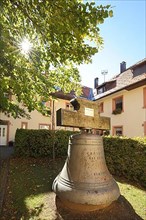 Bell in the courtyard of the monastery church of the Assumption of the Virgin Mary in the backlight in St. Maergen, Southern Black Forest
