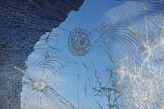 Shattered and broken glass pane with fractures, cracks and shapes