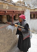Old Ladkhi woman with prayer wheels, Lamayuru Monastery or Lamayuru Gompa