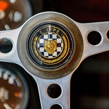Steering wheel of English historic classic sports car classic car roadster Jaguar E with logo emblem head of Jaguar lettering E-Type, fair Techno Classica