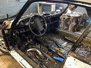 Gutted rusty body of historic classic sports car Classic Car Porsche 911 G model is prepared for restoration Reconstruction, Germany