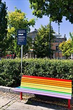 Bench in rainbow colours with welcome sign of the Oxlo initiative, Oslo Extra Large for diversity and integration