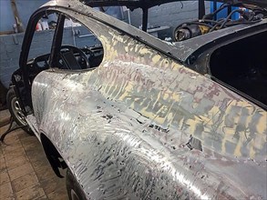Body of historic classic sports car classic car Porsche 911 G model is prepared for restoration reconstruction derusted stripped of paint, Germany