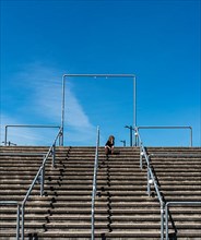 Lone spectator sitting on the steps to the stadium, Graefenhainichen