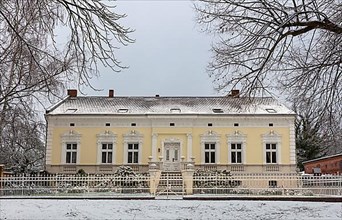 Winter, historic manor house on the village green in Luebars